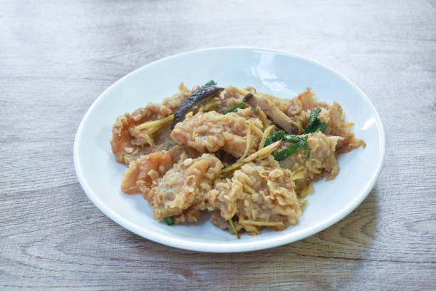 istock spicy deep fried slice bass fish with ginger and chili 1389695608