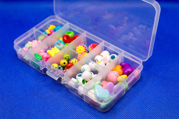 istock Plastic container with colored round buttons, jewelry for clothes in separate cells 1389695898