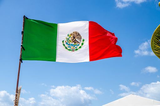 The Mexican flag against the blue sky