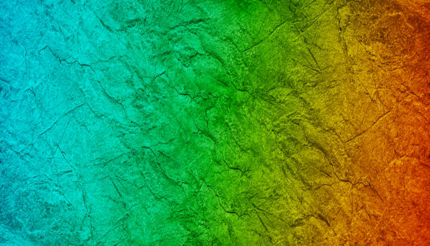 istock Beautiful abstract colorful texture. Multicolor green blue orange brown background. Gradient. Toned rough rock surface texture. 1389697981