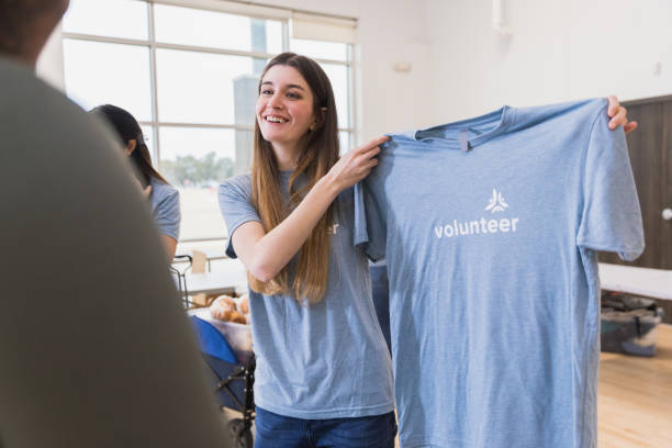 istock Volunteer holds up shirt 1389698908