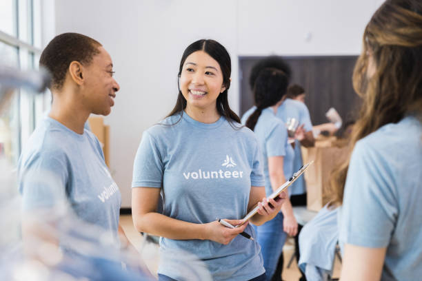 istock Three female volunteers take break to talk together 1389699478