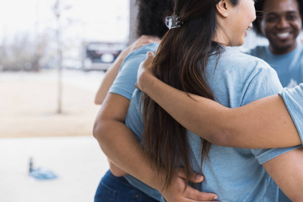 istock With arms around each other diverse volunteers show unity 1389699506