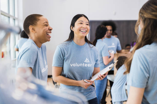istock Taking break from volunteering, three women talk and laugh together 1389699615