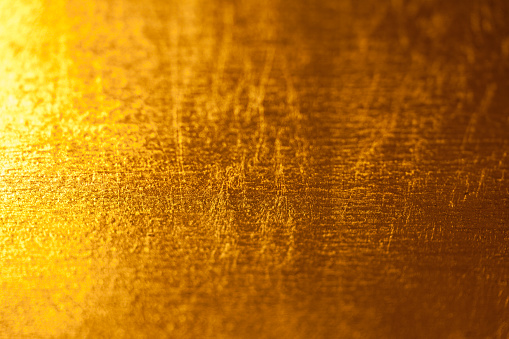 A gold painted wall, realistic gold texture. Gold surface.
