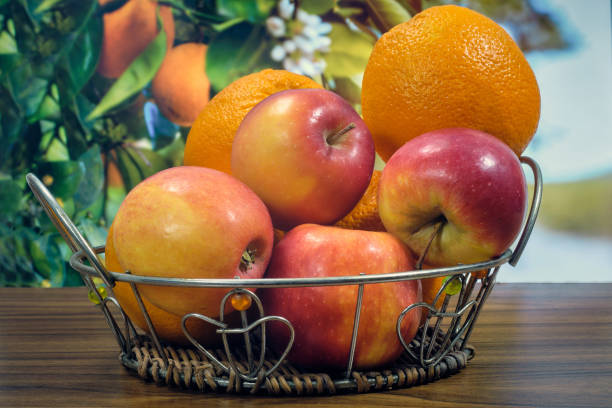 istock Oranges and apples on the table in a basket 1389700096