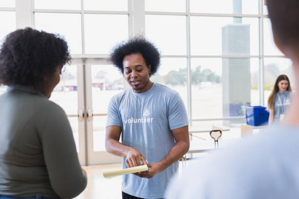 istock Young man helps with sign in 1389700303