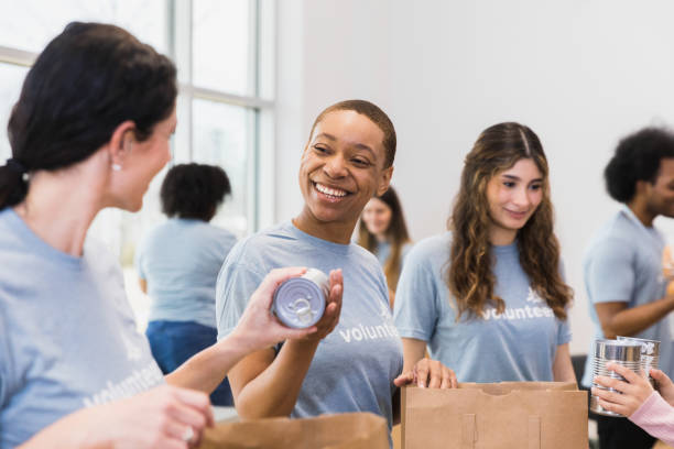 istock Young women smile while packing food 1389700312