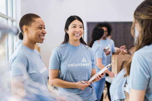 istock Pair of volunteers welcome new team 1389700837