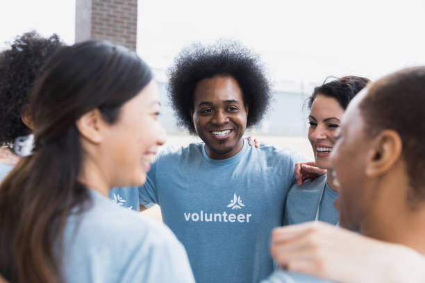 istock Multi-ethnic group of volunteers show unity 1389700962
