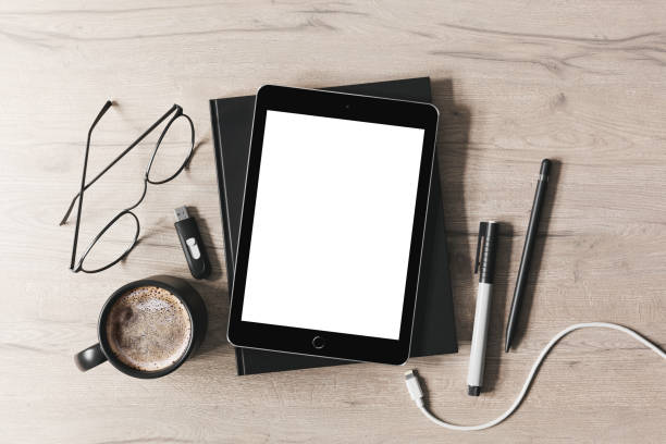 istock Tablet with various stationery on the table mockup 1389701388