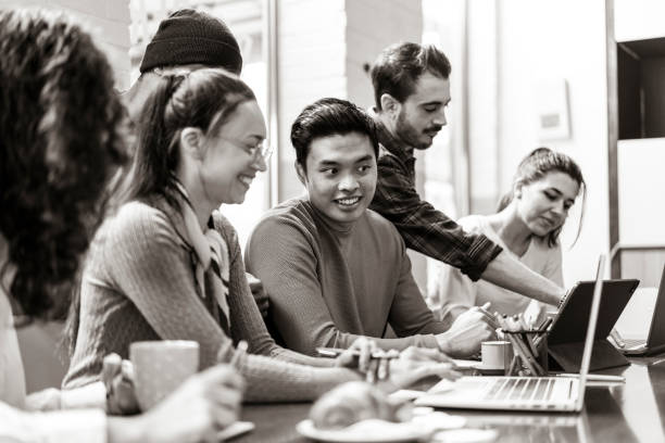 istock Young co-workers multiethnic team planning a new startup - Happy people working on a new project in creative coworking office - Marketing concept - Bright filter with focus on asian man face 1389701535