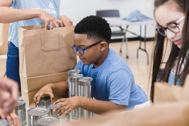 istock Children work hard as they  organize donated food 1389701694
