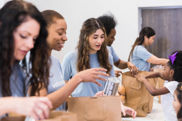 istock Cheerful volunteers pack food 1389702299