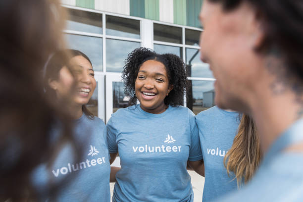 istock Women show unity before volunteering in community center 1389702367