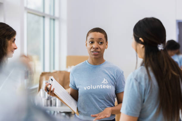 istock Three food drive coordinators discuss issues with volunteers 1389702390