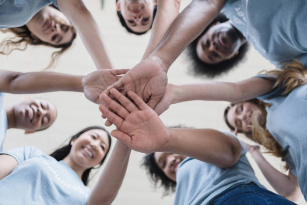 istock Underneath photo of the team stacking hands 1389702442