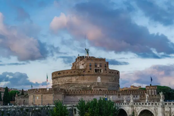 Photo of Rome Italy Castel SantAngelo evening view against sky with puffy clouds.