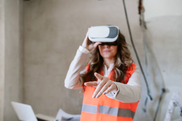istock architect woman in construction site using virtual reality goggles working on VR blueprints 1389702945