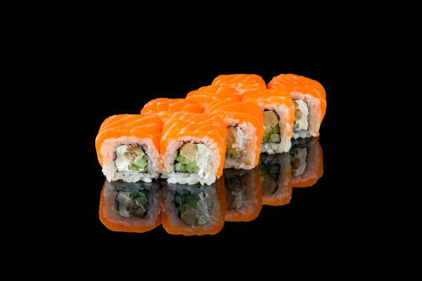 istock Philadelphia roll with salmon and eel on black with reflection 1389703923