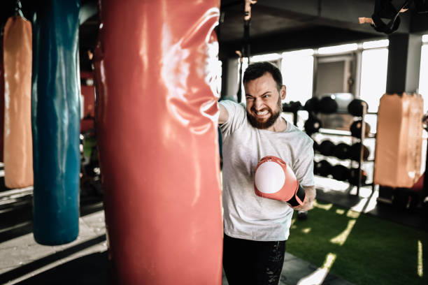 istock Angry Boxer Punching Heavy Bag As Part Of Workout 1389704152