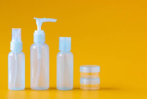 istock Set of empty mini blue bottles for cosmetics on a yellow background, side view, copy space. 1389704386