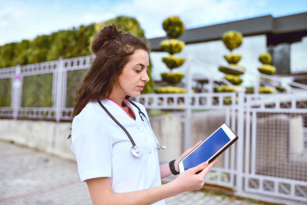 istock Nurse Using Work Break To Check Account Balance On Digital Tablet By Using Electronic Banking 1389705142