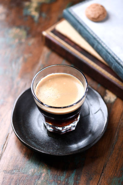 istock Coffee in glass cup on rustic wooden background. Close up. 1389705561
