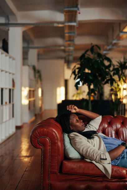istock Afro woman lying on sofa in psychotherapist office 1389705696