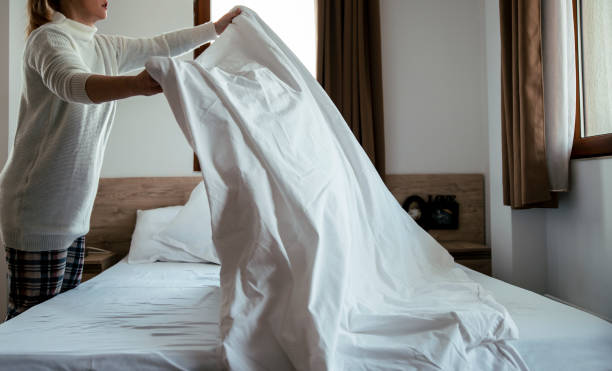 istock Woman makes the bed sheets 1389705894
