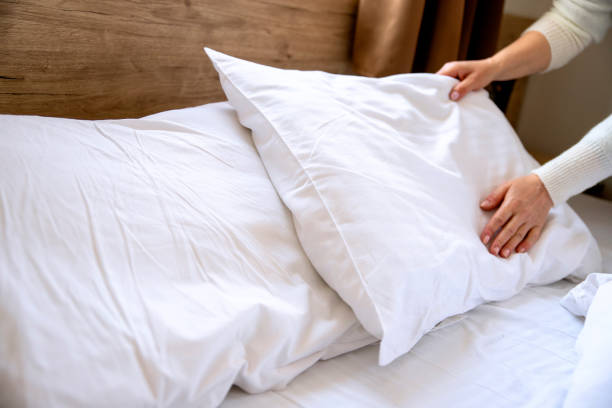 istock Female makes cushion in the bedroom 1389706526