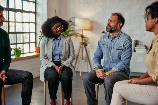 istock Man talking to the mental health support group 1389706567
