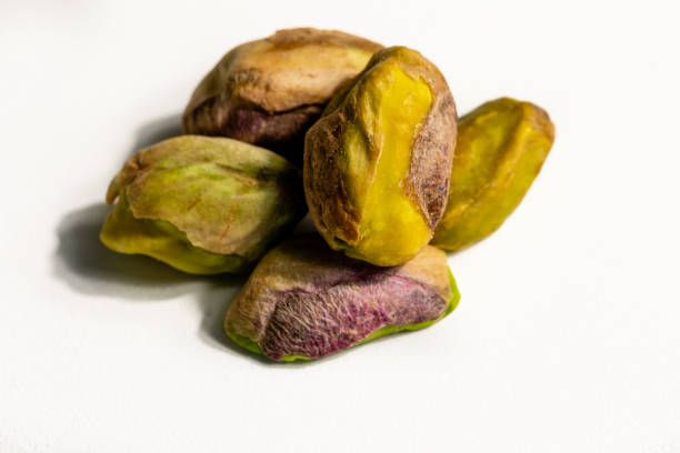 istock Peeled roasted pistachios isolated on white background 1389706865