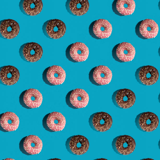 istock A pattern of delicious doughnuts on a blue background. Top view. Flat layer. 1389707013