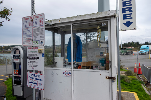 Anacortes, WA USA - circa November 2021: Close up view of a parking payment ticket booth outside of the Washington State Ferry terminal.