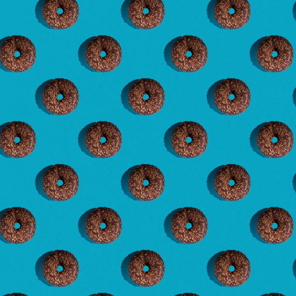 istock A pattern of delicious doughnuts on a blue background. Top view. Flat layer. 1389707985