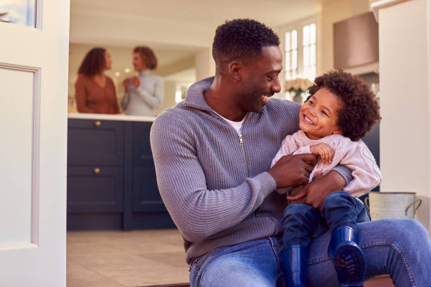 istock Father And Son Sit On Step At Home Putting On Boots Before Going On Family Walk 1389708427