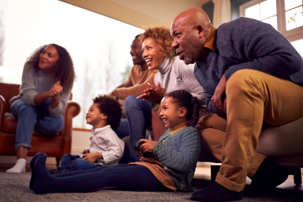 istock Multi-Generation Family Having Fun Playing Video Game In Lounge At Home Together 1389708631