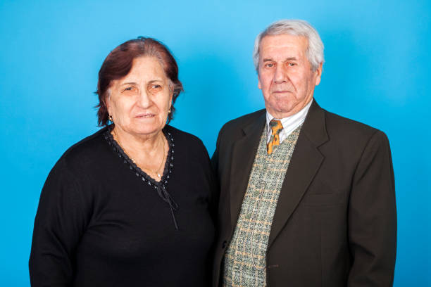Portraits of old woman and old man against a blue background