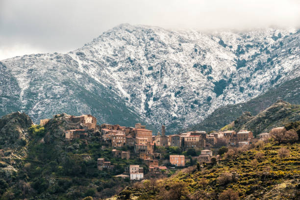 istock Speloncato and snow capped mountains in Corsica 1389709930
