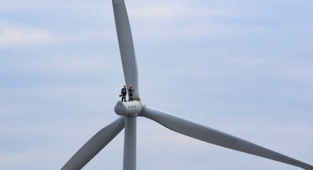 professional maintenance team working on wind turbine , green and renewable energy concept - turbine fotos stockfoto's en -beelden
