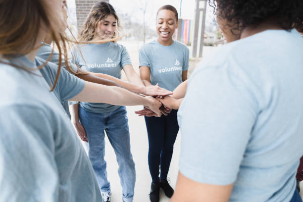 istock Young women volunteers stand in circle 1389710166