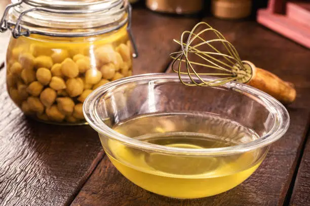 aquafaba in a kitchen pot, compote with organic chickpea legume water, used as a vegan alternative