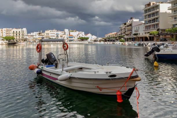 View of the embankment of the city Saint Nicholas, boats, a sea lake on a cloudy day (island Crete, Greece)