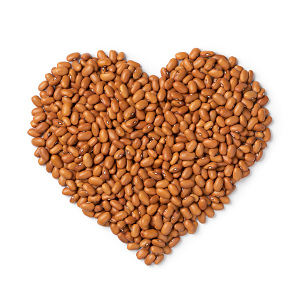 Borlotti beans, brown beans, in heart shape isolated on white background
