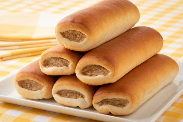 Heap of fresh baked sausage rolls close up for a snack Heap of Brabantian fresh baked sausage rolls close up for a snack up sausage roll stock pictures, royalty-free photos & images