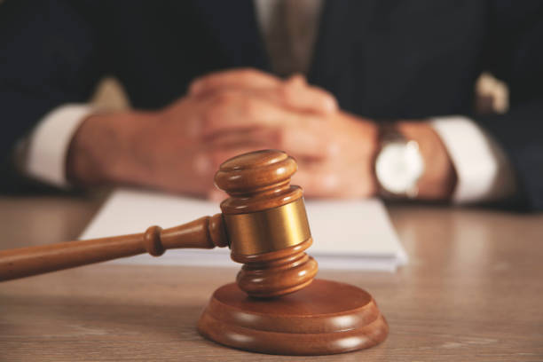istock man hand wooden judge with document 1389718133