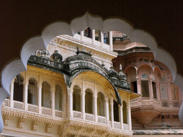 Sharp contrast of Red walls of Meherangarh Fort with Blue houses in Jodhpur in Rajasthan, India. The fort dominates the old part of the city, rising above the cluttered Blue dwellings. 