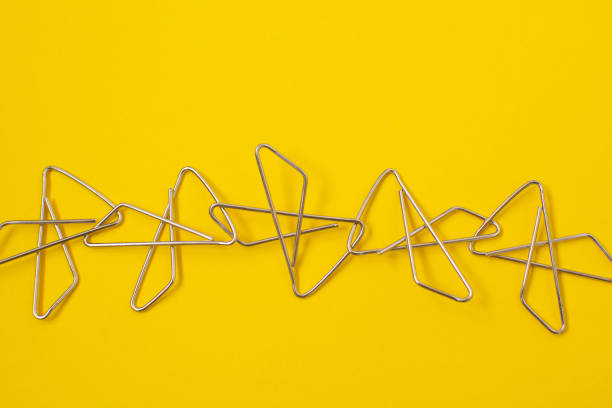 Paper clips attached to each other. Concept of partnership, cooperation, teamwork or joint venture