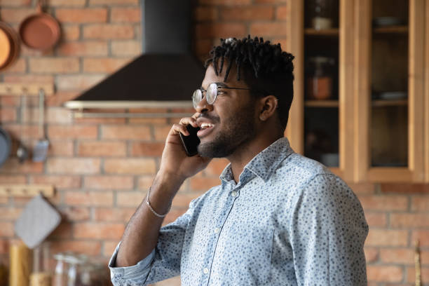 istock Handsome millennial African American hipster guy making telephone call 1389719831